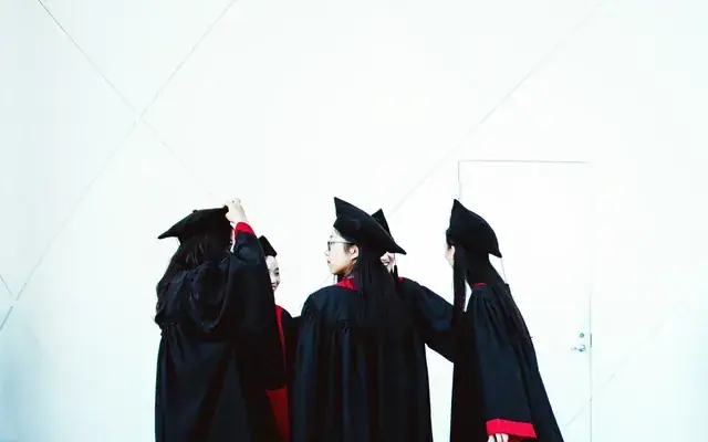 Graduates celebrating with caps in the air